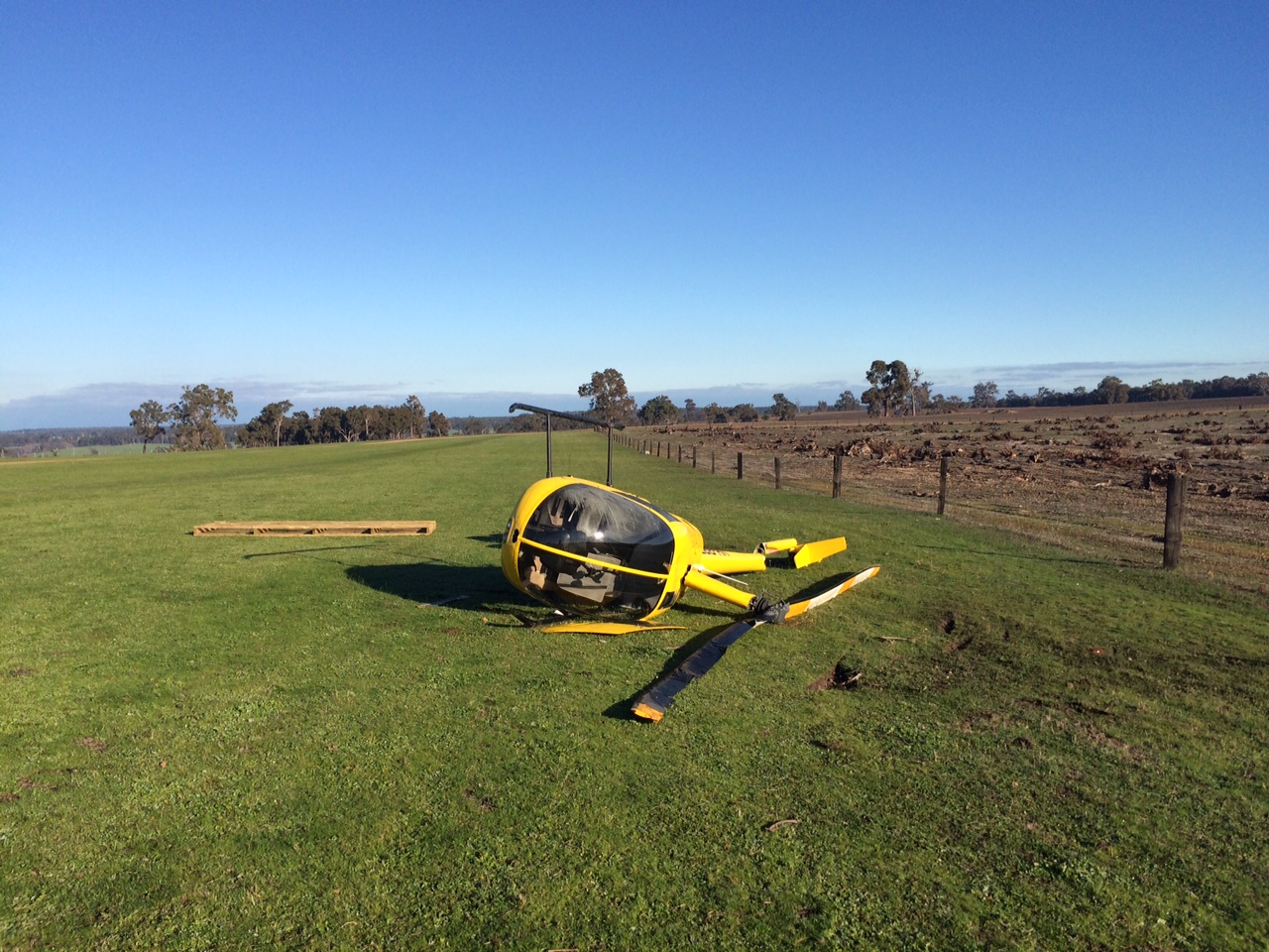 Figure 2: VH-RBT at rest on the left side. Note the broken tail boom and rotor blades